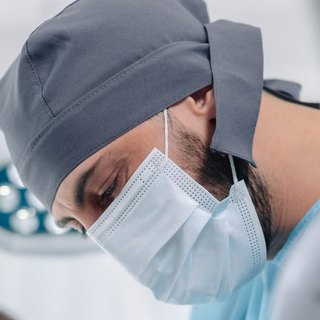Portrait of Dr. Zurab Kipshidze in a surgical cap and mask